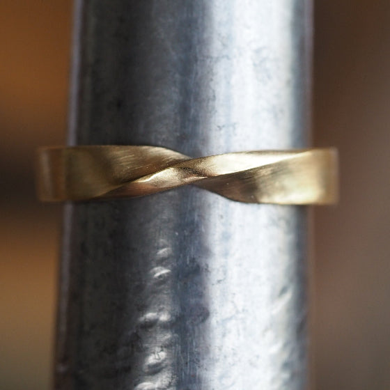 twisted gold ring on steel ring stick