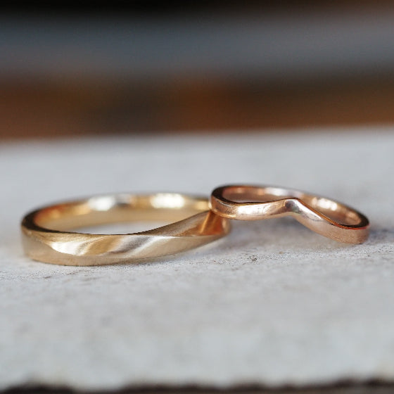 twisted yellow gold and v shaped rose gold wedding ring