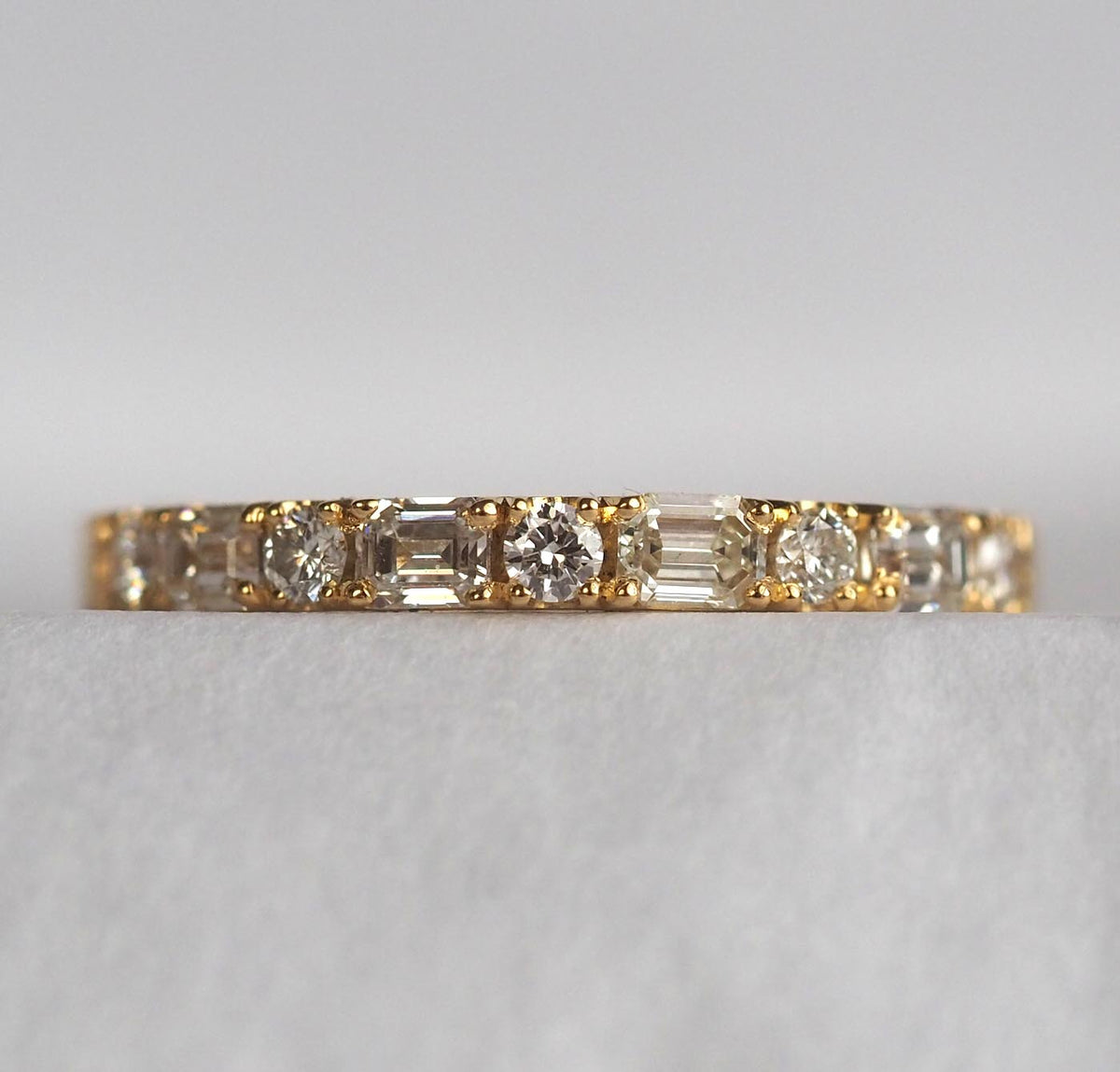 Emerald cut and round diamond ring